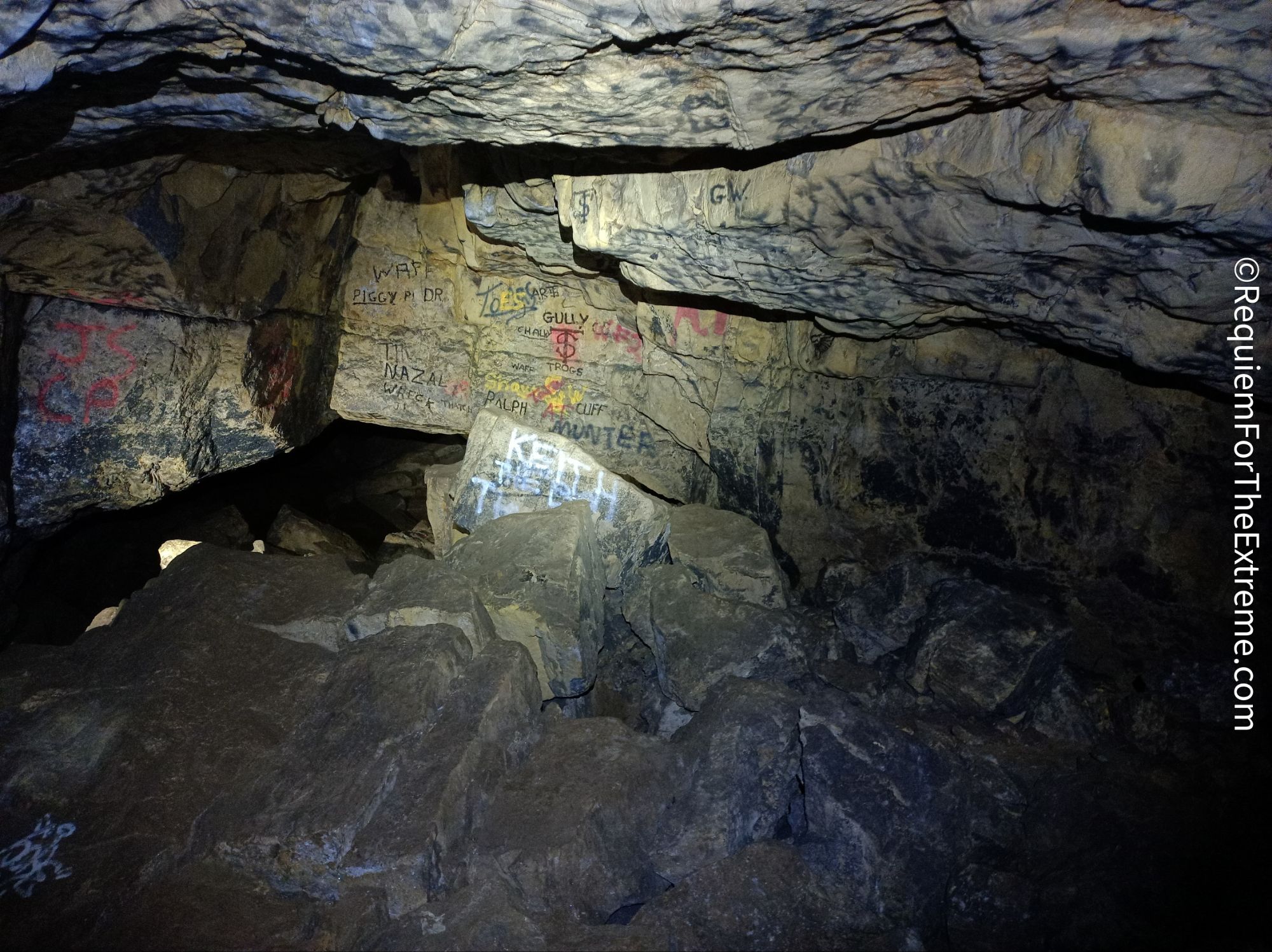 Boulder strewn around Cumberland Cavern, the walls are covered in the Graffiti Of The Troggs